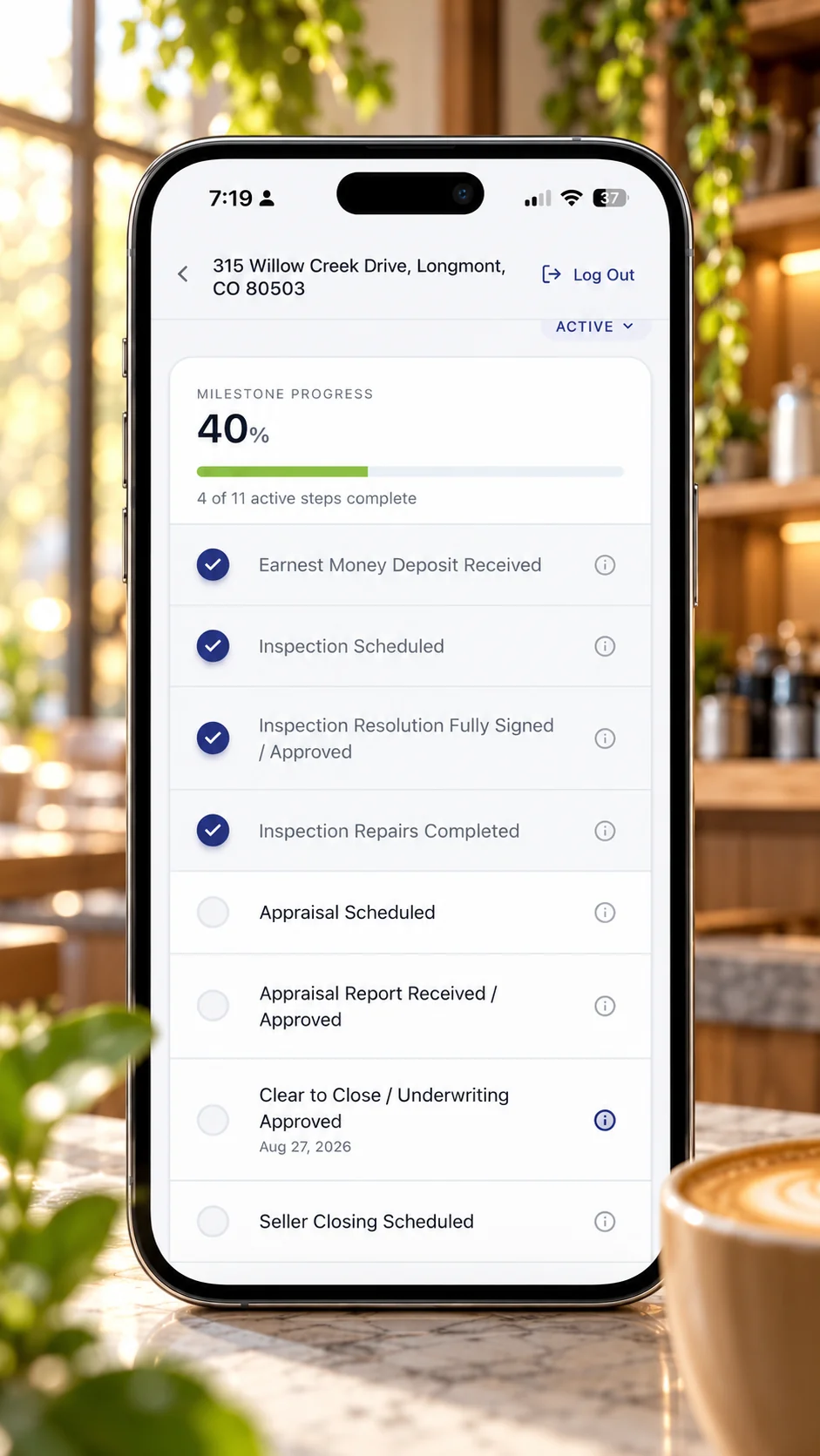 FilePace in a cafe: a phone showing milestone progress on a Longmont, Colorado transaction, beside a list of active Colorado transactions